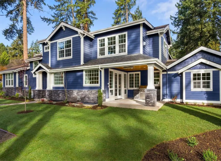 A blue house with white trim and windows.